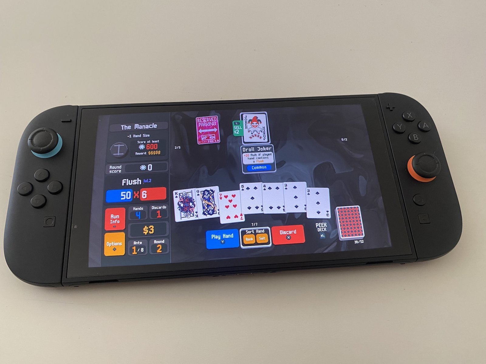 Balatro on Switch 2: the game running on a handheld console held in hand