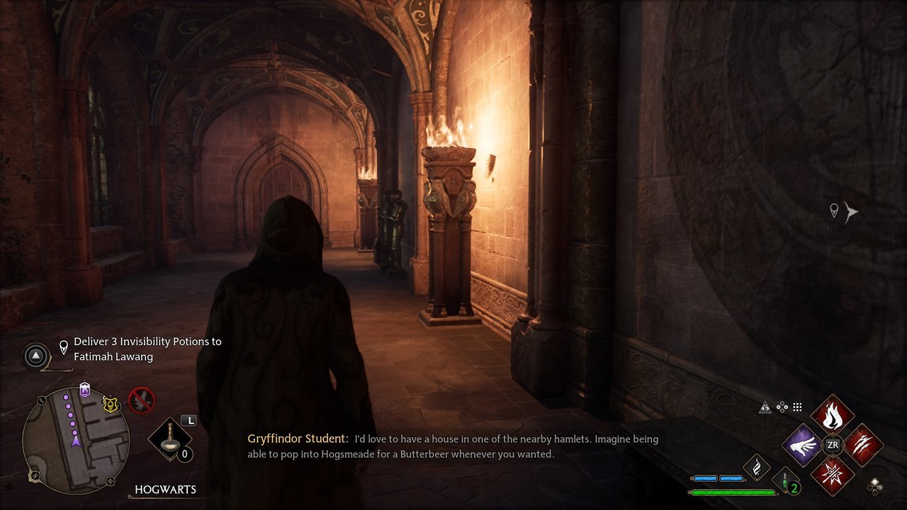 Hogwarts Legacy: a student in a torch-lit stone corridor while a classmate talks