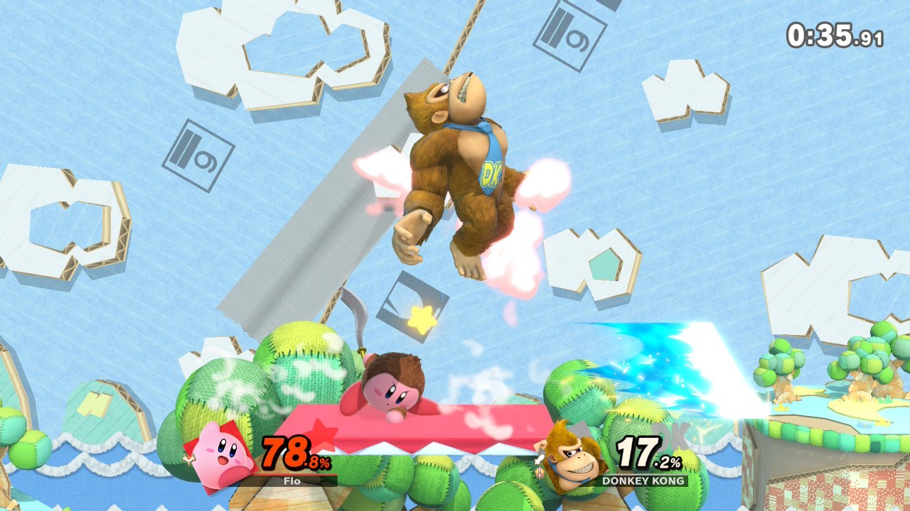 Kirby and Donkey Kong trading blows on a cardboard stage. Craft time got out of hand.